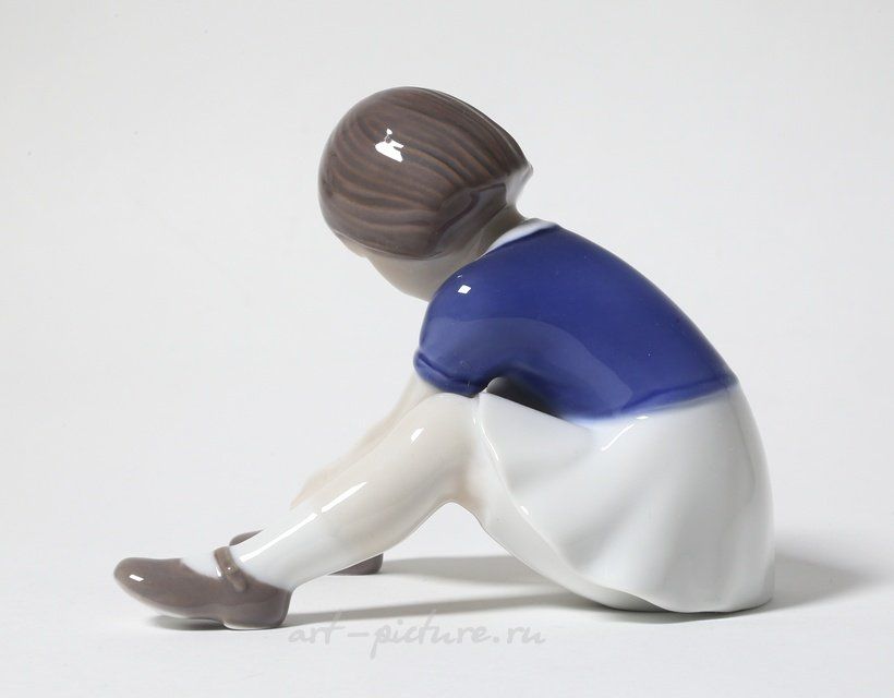 "Girl fastening her shoe. Denmark, Copenhagen, Bing & Grondahl."