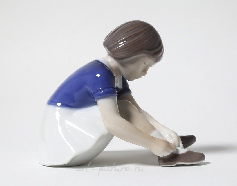 "Girl fastening her shoe. Denmark, Copenhagen, Bing & Grondahl."