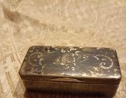 The word "Табакерка" translates to "snuffbox" or "tobacco box" in English.