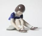 Статуэтка "Girl fastening her shoe…